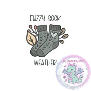May include: Illustration of two gray fuzzy socks with a heart and arrow design, with the words "FUZZY SOCK WEATHER". A small, circular graphic features a cartoon dragon with a pink bow.