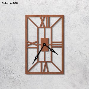 May include: A brown wooden clock with Roman numeral markings and black hands. The clock has a geometric design with a square frame and a rectangular center.