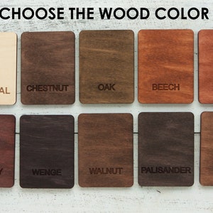 May include: Ten wood samples in different colors, labeled with their names: Natural, Chestnut, Oak, Beech, Alder, Cherry, Wenge, Walnut, Palisander, and Teak.