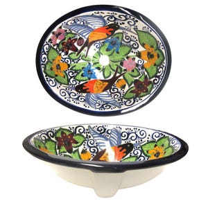 May include: Two hand-painted ceramic sinks. The sinks are white with a dark blue rim and feature a colorful floral and bird design. The upper sink is a separate oval basin, while the lower sink is a complete unit with a faucet opening.