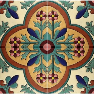 May include: A square ceramic tile featuring a symmetrical floral pattern in shades of cream, yellow, terracotta, teal, and dark blue. The design includes stylized flowers with pink petals and yellow centers, surrounded by green leaves and dark blue accents.