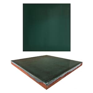 May include: A square green ceramic tile with a slightly textured surface. The tile is shown from the top and the side, revealing a reddish-brown edge.
