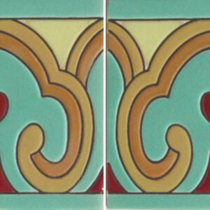 May include: Two square ceramic tiles featuring a repeating decorative pattern. The design includes a central teal shape outlined in orange and yellow, with a small red teardrop element at the top and red triangular accents at the bottom corners.
