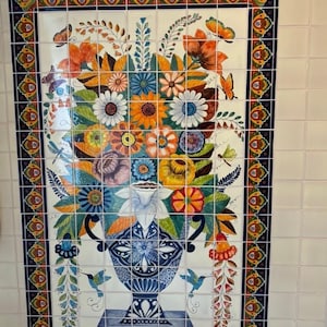 May include: A colorful ceramic tile mural depicting a vase filled with flowers and hummingbirds. The vase is blue and white with a floral design. The flowers are in shades of pink, yellow, orange, and red. The hummingbirds are green and blue.