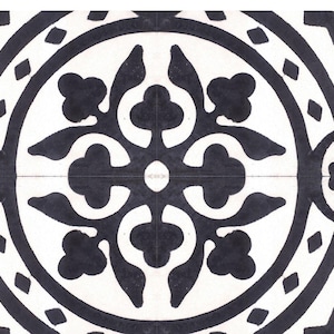 May include: Black and white tile with a geometric pattern. The pattern features a central circle with four stylized floral motifs.
