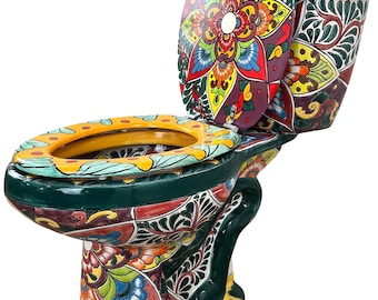 May include: A ceramic toilet featuring a vibrant, multi-colored hand-painted floral and geometric pattern. The design includes shades of deep green, yellow, red, blue, and orange across the bowl, tank, and lid, creating a bold, decorative appearance.