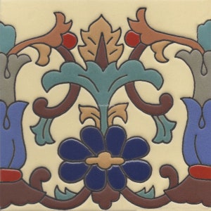 May include: A decorative tile featuring a floral design. The tile depicts a blue flower with a yellow centre, surrounded by brown, green and red leaves. The tile has a cream background.