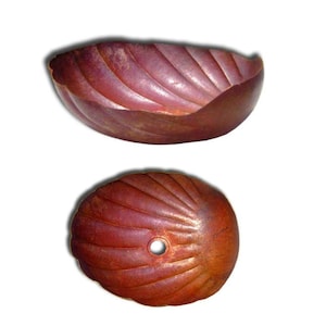 May include: Two copper bowls with a scalloped design. The bowls are a deep reddish-brown color.