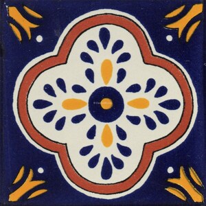 May include: Square ceramic tile with a floral design. The tile features a central white quatrefoil shape with blue and yellow accents, outlined in red. The background is a deep blue, with yellow decorative elements in the corners.