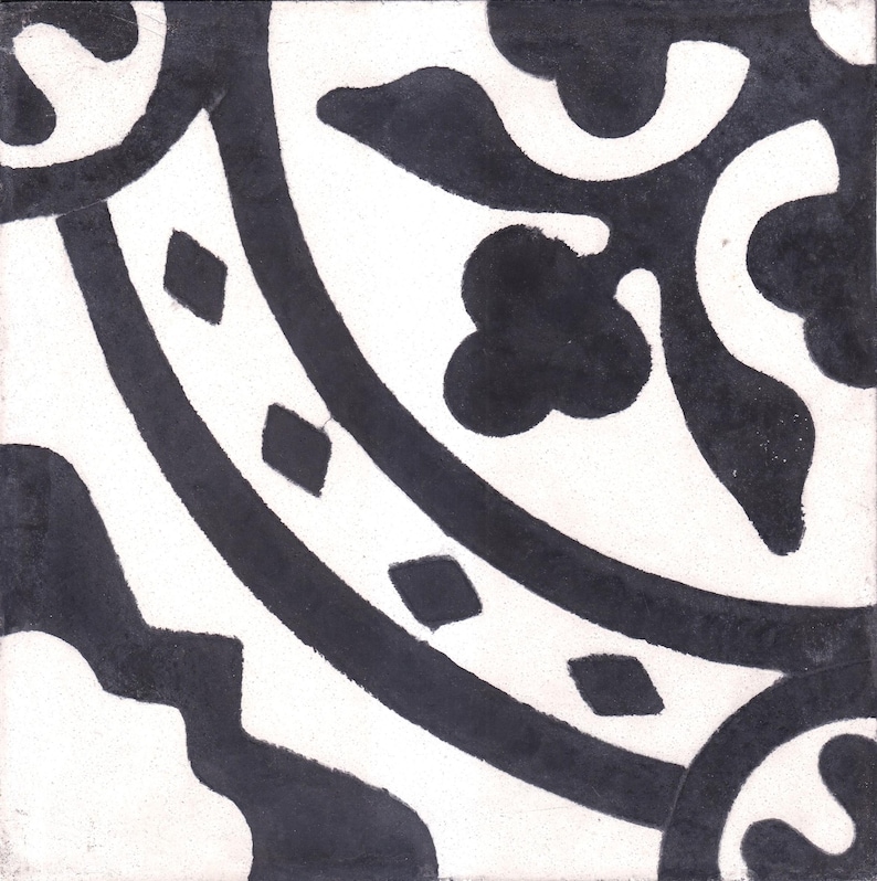 May include: Black and white ceramic tile with a geometric pattern. The tile features a repeating design of circles, diamonds, and floral motifs.