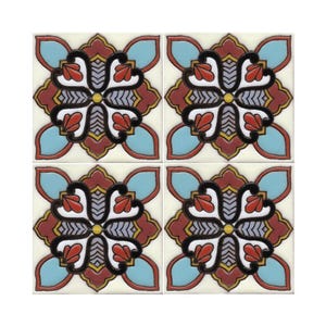 May include: Four square ceramic tiles with a repeating pattern of a stylized flower with red, yellow, blue, black, and white accents.
