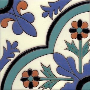 May include: A white ceramic tile with a blue, green, black, and orange floral design. The tile features stylized flowers and leaves.