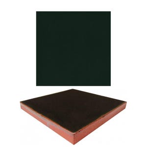 May include: A dark brown square object with a red border. The object appears to be made of wood or a similar material. The background is white.