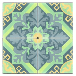 May include: A square tile with a green, yellow, and blue floral pattern. The tile has a geometric design in the corners.