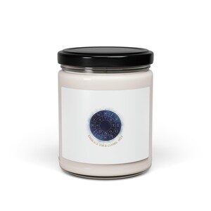 Peut inclure: Une bougie blanche dans un bocal en verre avec un couvercle noir. L'étiquette présente un motif de roue du zodiaque bleu et or avec le texte "EMBRACE YOUR COSMIC SELF".