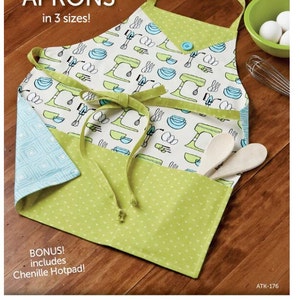 May include: A colorful apron with a green and white pattern, featuring kitchen utensils and the text "Mom and Me APRONS in 3 sizes!". Includes a bonus chenille hotpad. Wooden spoons are in the pocket.