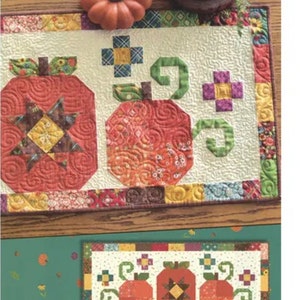 May include: Pumpkin Trio quilt pattern featuring three pumpkins with different designs and a border of colorful fabric squares. The pattern is 5" square friendly and is by Anka's Treasures.