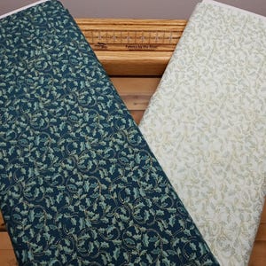 A Festive Medley Holly & Scroll by Jackie Robinson for Benartex - 2657M Dark and Light Teal with Metallic Gold. SOLD In 1/2 YARD INCREMENTS