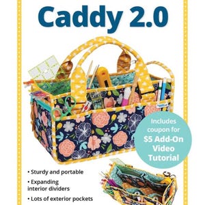 May include: Catch All Caddy 2.0, a floral print fabric organizer with a yellow handle and trim. Features include expanding interior dividers and exterior pockets. Includes a coupon for a video tutorial. The text reads: Organize and carry all your supplies!