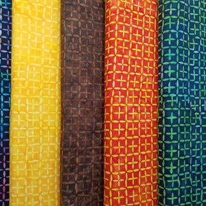 May include: Five fabric swatches with a crosshatch pattern. The swatches are in shades of blue, yellow, brown, red, and green.