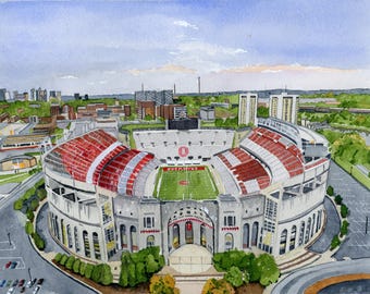 May include: Watercolor painting of a large stadium with red and white seating. The stadium has a green field with the word "Buckeyes" visible. The sky is blue with some clouds, and a city skyline is in the background.