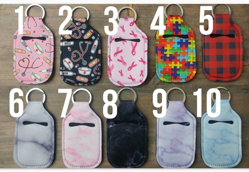 May include: Ten different designs of hand sanitizer holders with keychains. The holders are made of a soft, flexible material and have a clear window for easy access to the sanitizer. The designs include a nurse theme, pink ribbons, puzzle pieces, plaid, marble, and more.