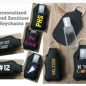 May include: Black hand sanitizer keychain holders with various personalized text, including "PHS", "Be Kind", "You Got This!", "#12", "HALEIGH", and "Be The Change".