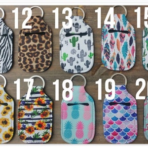 May include: Twenty different hand sanitizer holders with keychains. The holders are made of fabric and feature various patterns, including zebra, leopard, cactus, feathers, sunflowers, pineapples, and flamingos.
