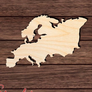 May include: A wooden cutout of the continent of Europe. The cutout is a light brown color and is set against a dark brown wood background. The cutout is a simple outline of the continent, with no details of individual countries.
