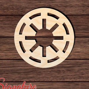 May include: A wooden cutout of the Star Wars Galactic Empire logo. The logo is a circle with a central starburst and a ring of concentric circles around it.