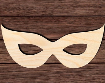 May include: A wooden mask in the shape of a masquerade mask. The mask is light brown and has a simple design.