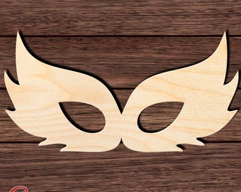 May include: A wooden cutout of a masquerade mask with a feathered design. The mask is light brown and has a simple, elegant shape.