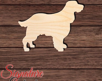 May include: A light-colored, unfinished wooden cutout in the shape of a standing dog with long, feathered fur on its legs and tail. The silhouette features a distinct snout, floppy ears, and a sturdy stance, showcasing the natural wood grain texture.