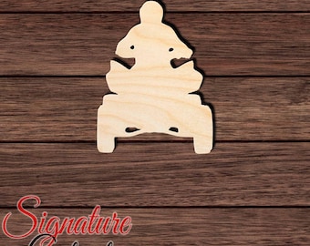 May include: A light-colored, unfinished wooden cutout in the shape of an all-terrain vehicle with a rider. The silhouette shows the front view of the four-wheeled vehicle and the upper body of the person operating it, featuring smooth, flat edges.