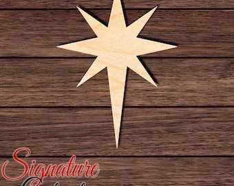 May include: A light-colored wooden star cutout with eight points of varying lengths, featuring a long bottom point and a symmetrical design. The surface shows a natural wood grain texture. The text Signature Cutouts is visible in the corner.