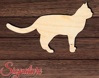 May include: A light-colored wooden cat cutout silhouette featuring a smooth surface and natural grain patterns. The cat is depicted in a standing profile position with its tail extended horizontally and ears pointed upward.