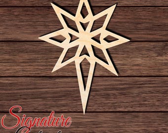 May include: A light-colored wooden star cutout with a geometric, multi-pointed design featuring symmetrical diamond-shaped cutouts throughout the center and elongated points. The text Signature Cutouts is visible in the bottom left corner.