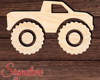 May include: A light-colored wooden cutout in the shape of a monster truck with large, knobby tires and a cab. The cutout features a smooth, flat surface and a distinct silhouette of a vehicle with oversized wheels, presented as a single piece.