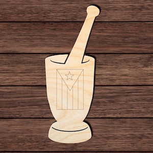 May include: A light-colored wooden mortar and pestle cutout featuring a laser-engraved design of the Puerto Rican flag on the front of the mortar. The object has a smooth, flat surface and a distinct silhouette of a traditional kitchen tool.