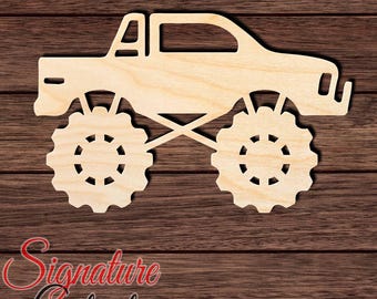 May include: A light-colored wooden cutout in the shape of a monster truck with large, knobby tires and a cab. The cutout features a flat, unfinished wood grain surface and is presented as a decorative shape for various craft projects.