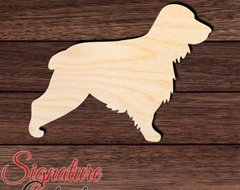May include: A light-colored wooden cutout in the shape of a dog standing in profile. The silhouette features a long-haired coat with jagged edges along the chest and legs, a short tail, and a rounded snout, presented as a flat decorative piece.
