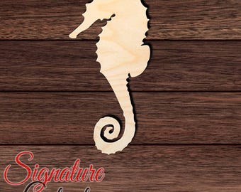 May include: A light-colored, flat wooden seahorse cutout featuring a distinct curved tail, a textured dorsal fin, and a snout. The surface displays a natural wood grain pattern with visible light brown tones throughout the entire shape.