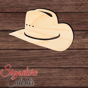 May include: A light-colored wooden cutout in the shape of a cowboy hat. The flat, two-dimensional silhouette features a wide brim, a tall crown, and three small, evenly spaced circular cutouts on the side of the crown representing hat details.