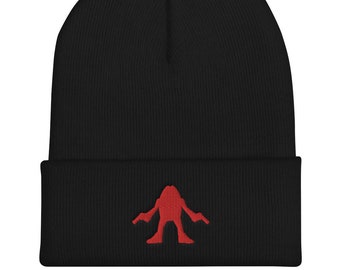 May include: Black beanie with a red embroidered monster design.