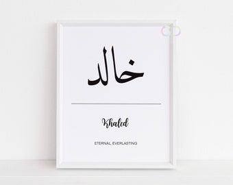 May include: A white framed print with black Arabic calligraphy that reads "Khaled" in English below. The meaning of the name is "Eternal, Everlasting" in English.