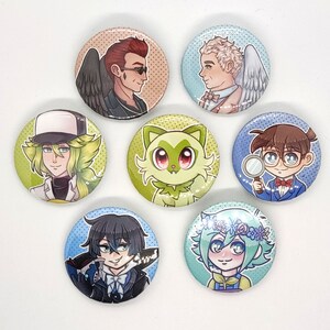 May include: Set of 7 round button pins featuring various cartoon characters. The characters include a green cat, a person with green hair wearing a white hat, a person with brown hair wearing a blue suit, a person with black hair wearing a black suit, a person with blonde hair wearing a white shirt, and a person with brown hair wearing a white shirt.