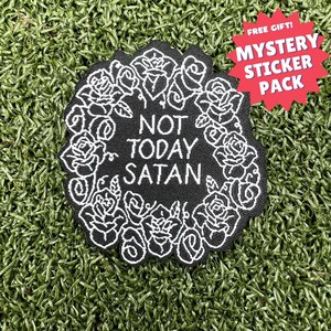 May include: Black embroidered patch with white roses and the text "Not Today Satan".