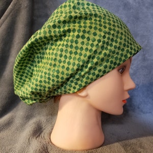 May include: Green and yellow patterned scrub hat with a tie at the back.