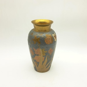 May include: A decorative vase with a gold rim and base, and a grey body. The vase is adorned with floral and leaf designs in shades of orange, gold, and white. The vase is approximately 20 cm tall.