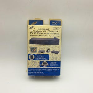 以下が含まれることがあります： コンパクトなPS2ワイヤレスAVセレクター、DVDリモコン、マルチタップのパッケージ。黒いデバイス、接続されたコンポーネントのイラスト、および「ワイヤレスコントロール、マルチプレイヤーアクション、組織化とスタイル」というテキストが特徴です。